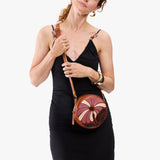 Wildflower Sienna Small | Model wearing circle shaped crossbody bag with top zipper