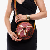 Wildflower Sienna Small | Model holding circle shaped crossbody bag with top zipper