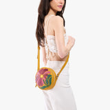 Wildflower Sunshine Small | Model wearing circle shaped crossbody bag with top zipper