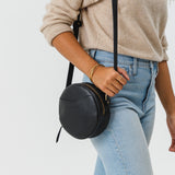 Pebbled--black Small | Circle shaped crossbody bag with top zipper
