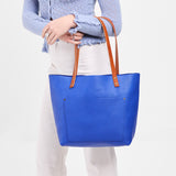 Astro Blue Classic | Model wearing large leather tote bag with sturdy bridle handles and front pocket