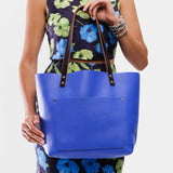 Astro Blue Classic | Model wearing large leather tote bag with sturdy bridle handles and front pocket