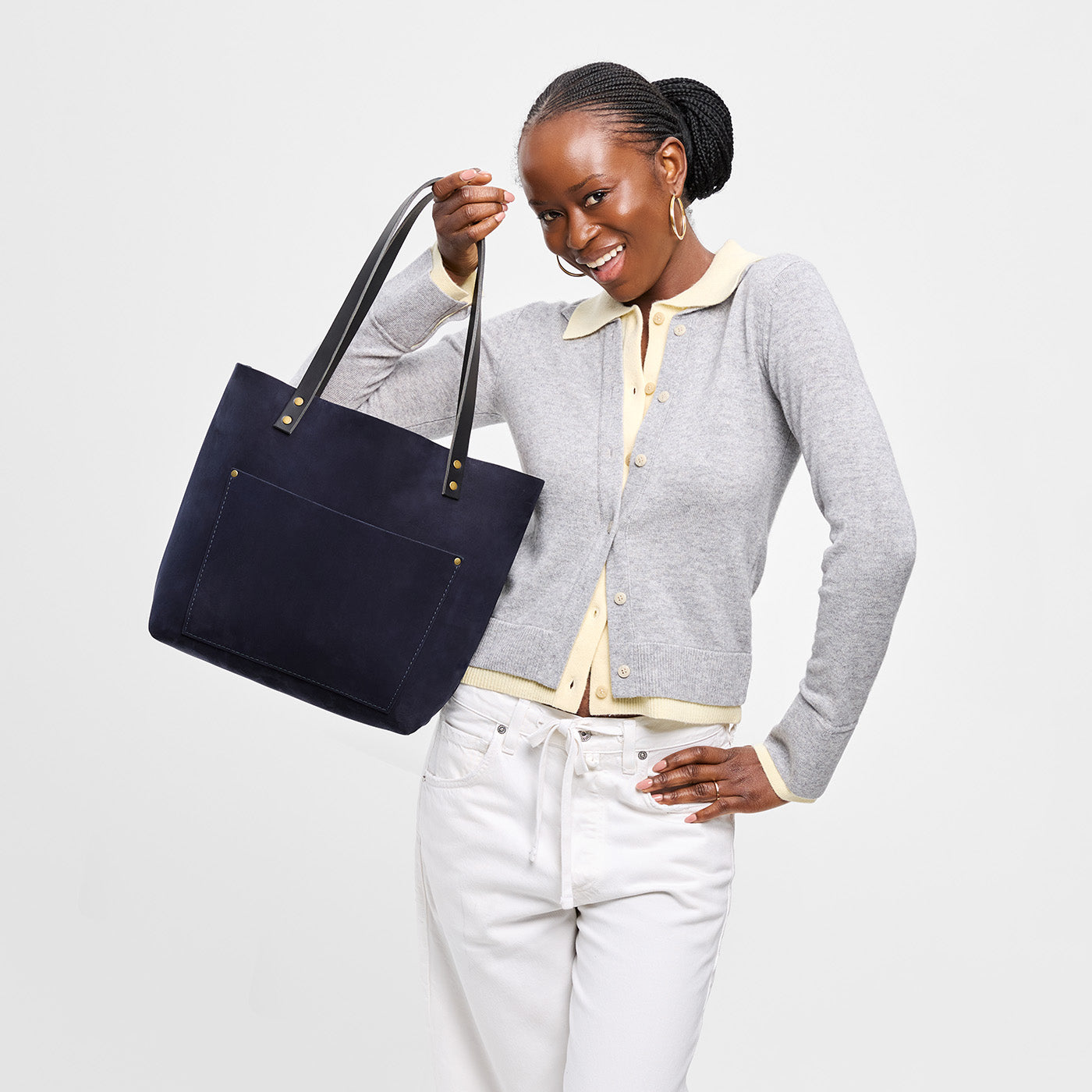 Velvet Blue*Classic | Model holding large leather tote bag with sturdy bridle handles and front pocket