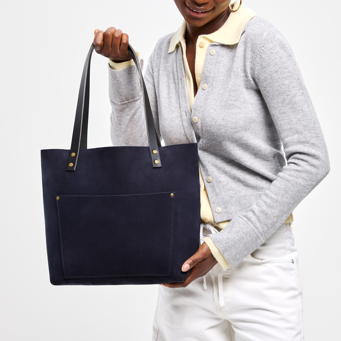 Velvet Blue*Classic | Model holding large leather tote bag with sturdy bridle handles and front pocket
