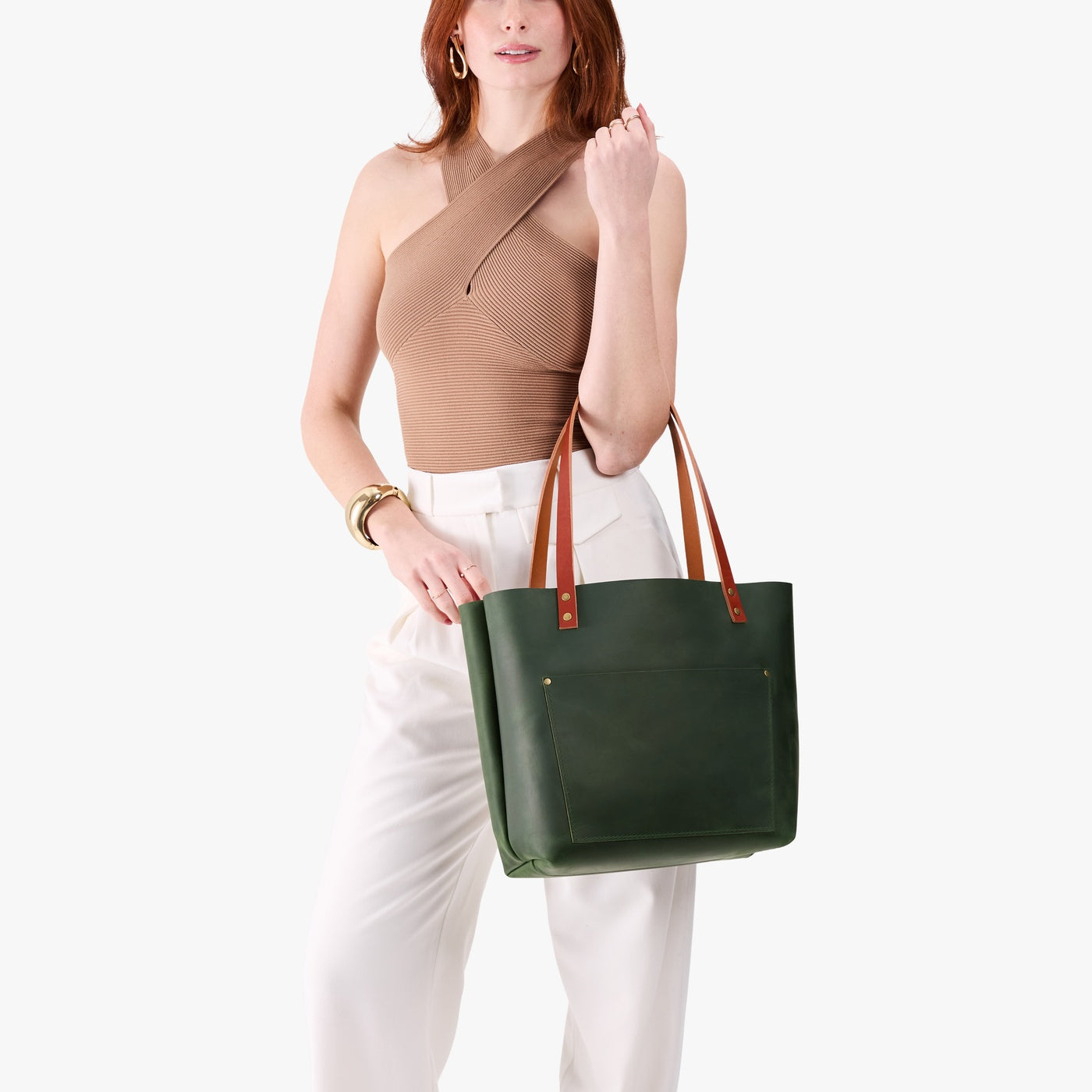 Evergreen*Classic | Model holding large leather tote bag with sturdy bridle handles and front pocket