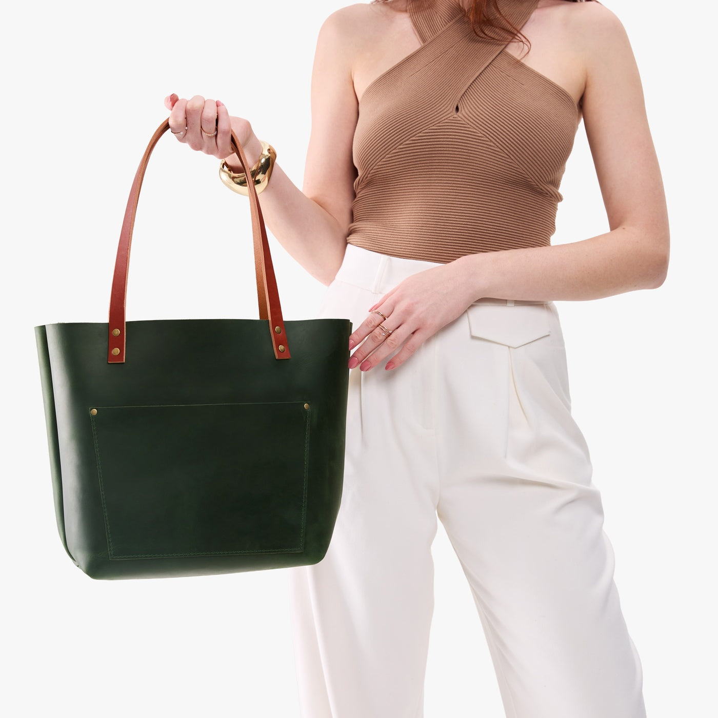 Evergreen*Classic | Model holding large leather tote bag with sturdy bridle handles and front pocket