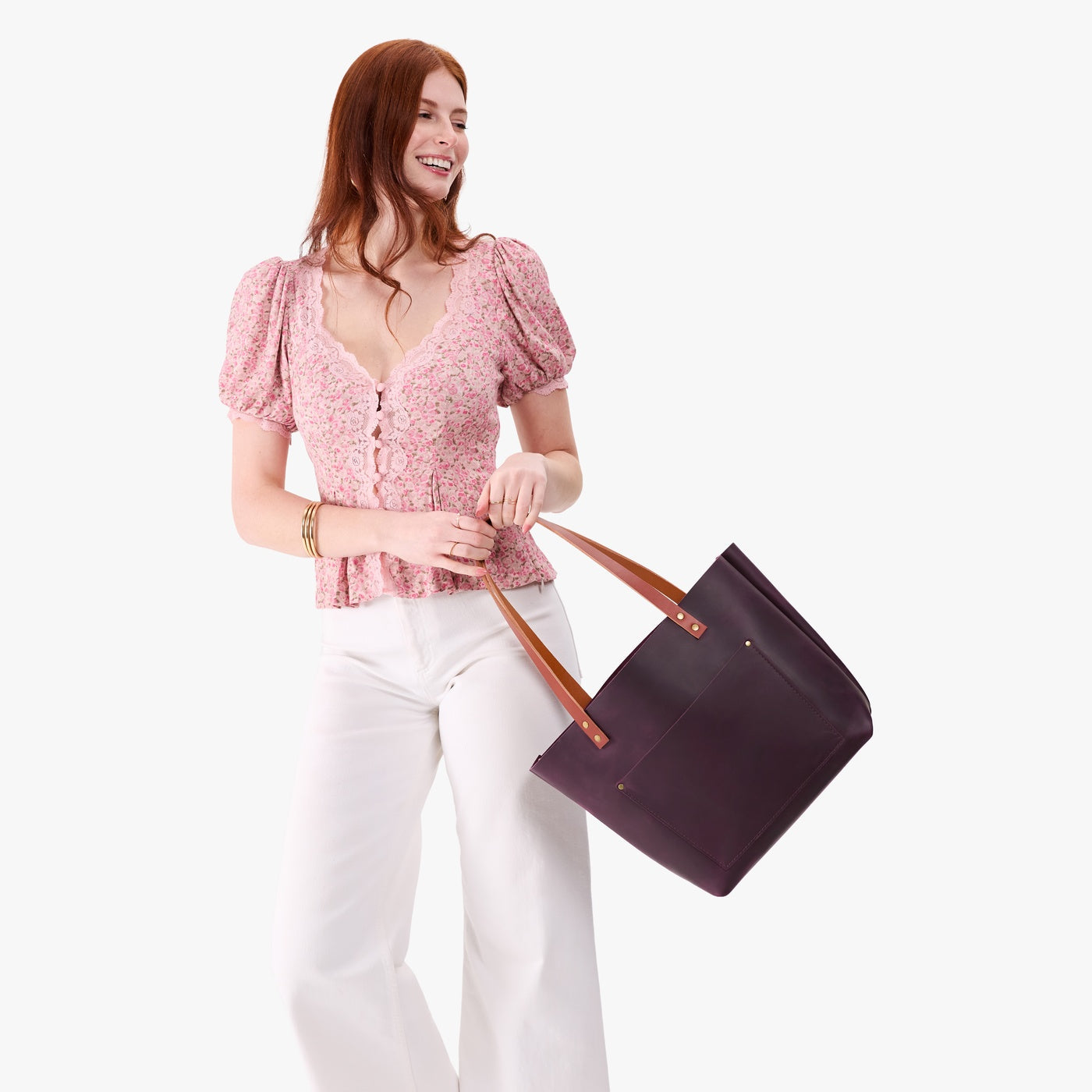 Larkspur*Classic | Model holding large leather tote bag with sturdy bridle handles and front pocket