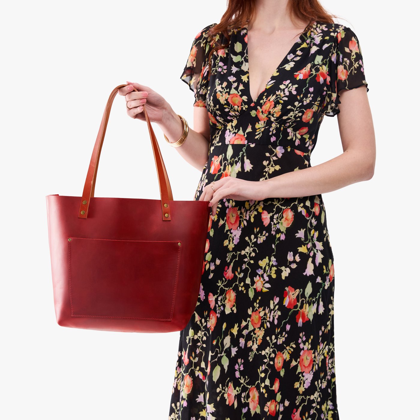Phoenix*Classic | Model holding large leather tote bag with sturdy bridle handles and front pocket