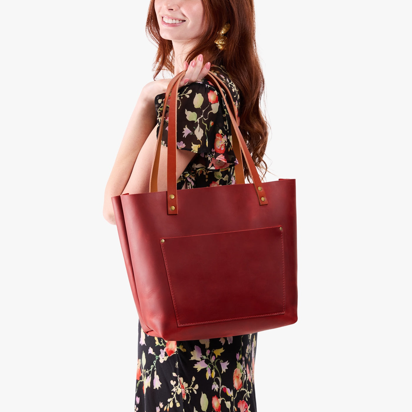 Phoenix*Classic | Model holding large leather tote bag with sturdy bridle handles and front pocket