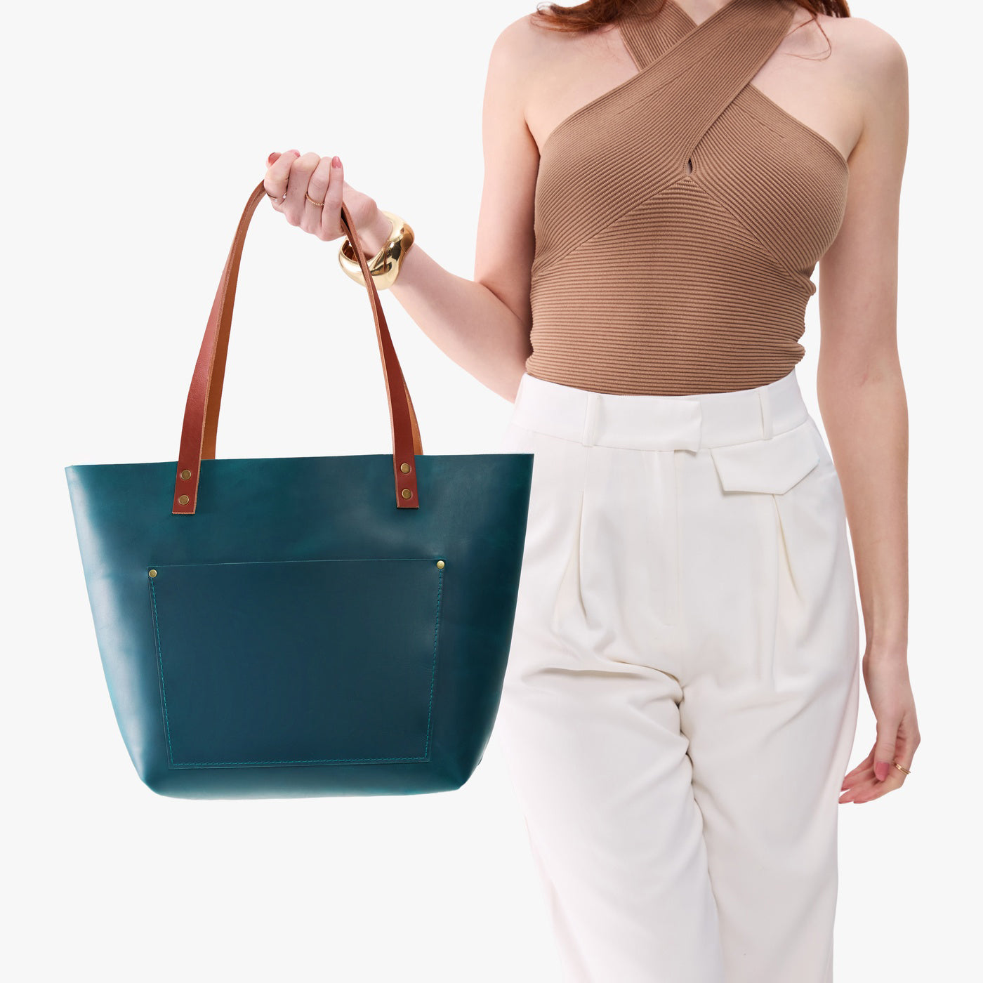Westward Blue*Classic | Model holding large leather tote bag with sturdy bridle handles and front pocket