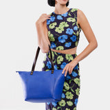 Astro Blue Zipper | Model wearing large leather tote bag with sturdy bridle handles and front pocket