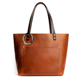 Silver | Circular metal purse hanger clipped onto a bag