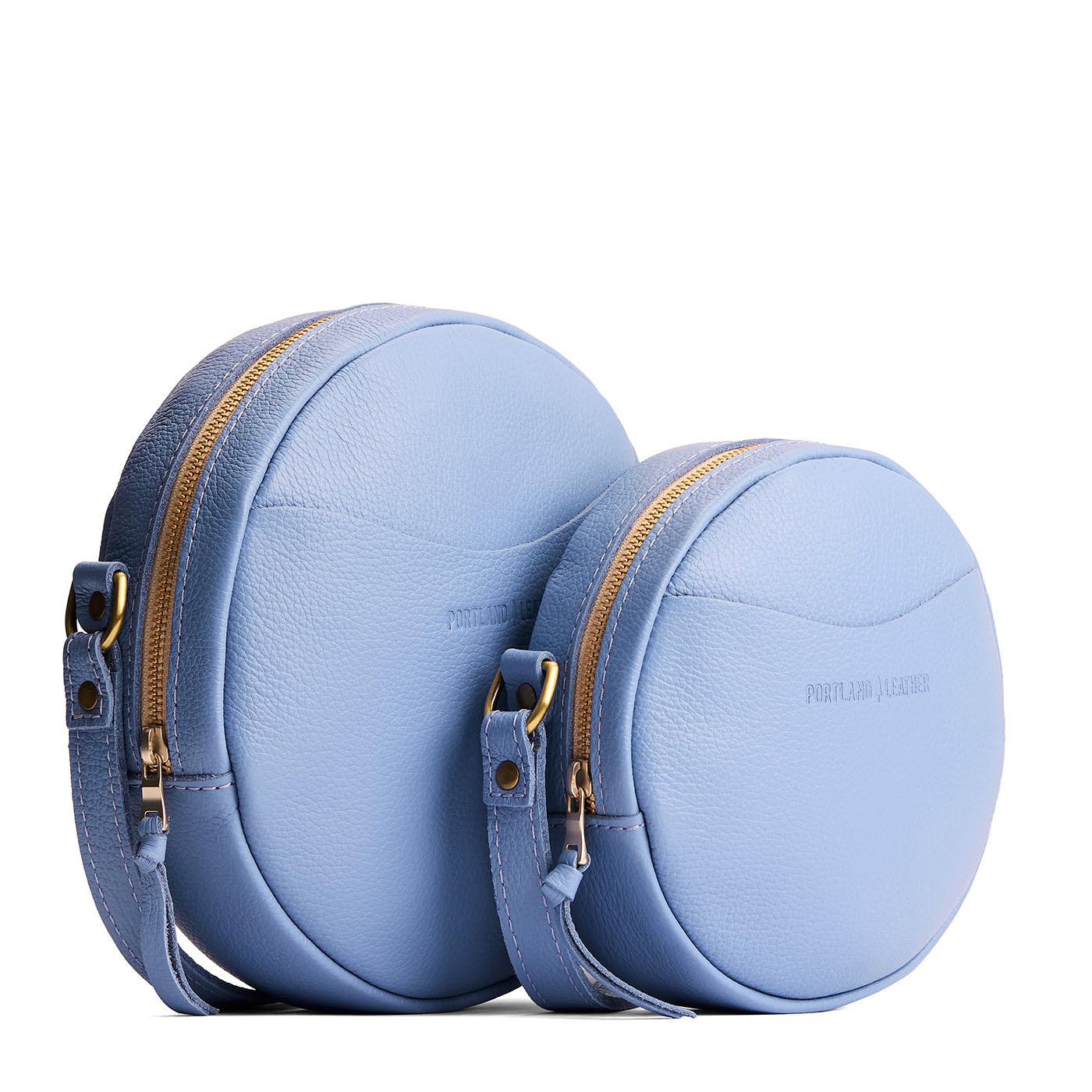 Aster | Size comparison image of small and large circle shaped crossbody bags with top zipper