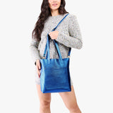 Comet Blue Classic | Model holding medium Tote with dual shoulder straps and crossbody strap