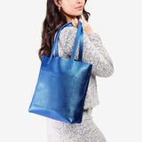 Comet Blue Classic | Model holding medium Tote with dual shoulder straps and crossbody strap