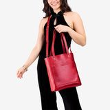 Reba Red Classic | Model holding medium Tote with dual shoulder straps and crossbody strap
