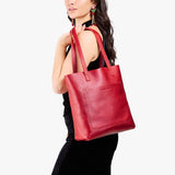 Reba Red Classic | Model holding medium Tote with dual shoulder straps and crossbody strap