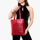 Reba Red Classic | Model holding medium Tote with dual shoulder straps and crossbody strap
