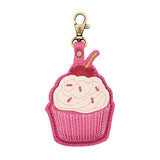 Wild Rose | A cupcake-shaped leather keychain charm with cream-colored frosting, a red cherry on top