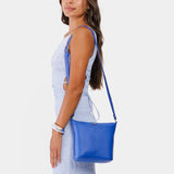 Astro Blue | Model wearing rectangular side bag with curved front pocket and metal tree shaped badge