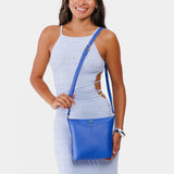 Astro Blue | Model wearing rectangular side bag with curved front pocket and metal tree shaped badge