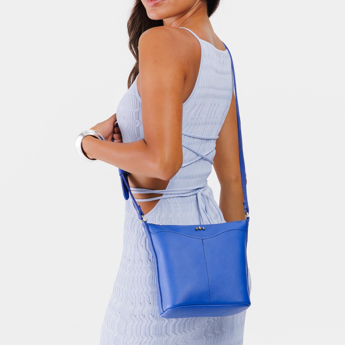 Astro Blue | Model wearing rectangular side bag with curved front pocket and metal tree shaped badge