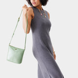 Beetle | Model wearing rectangular side bag with curved front pocket and metal tree shaped badge