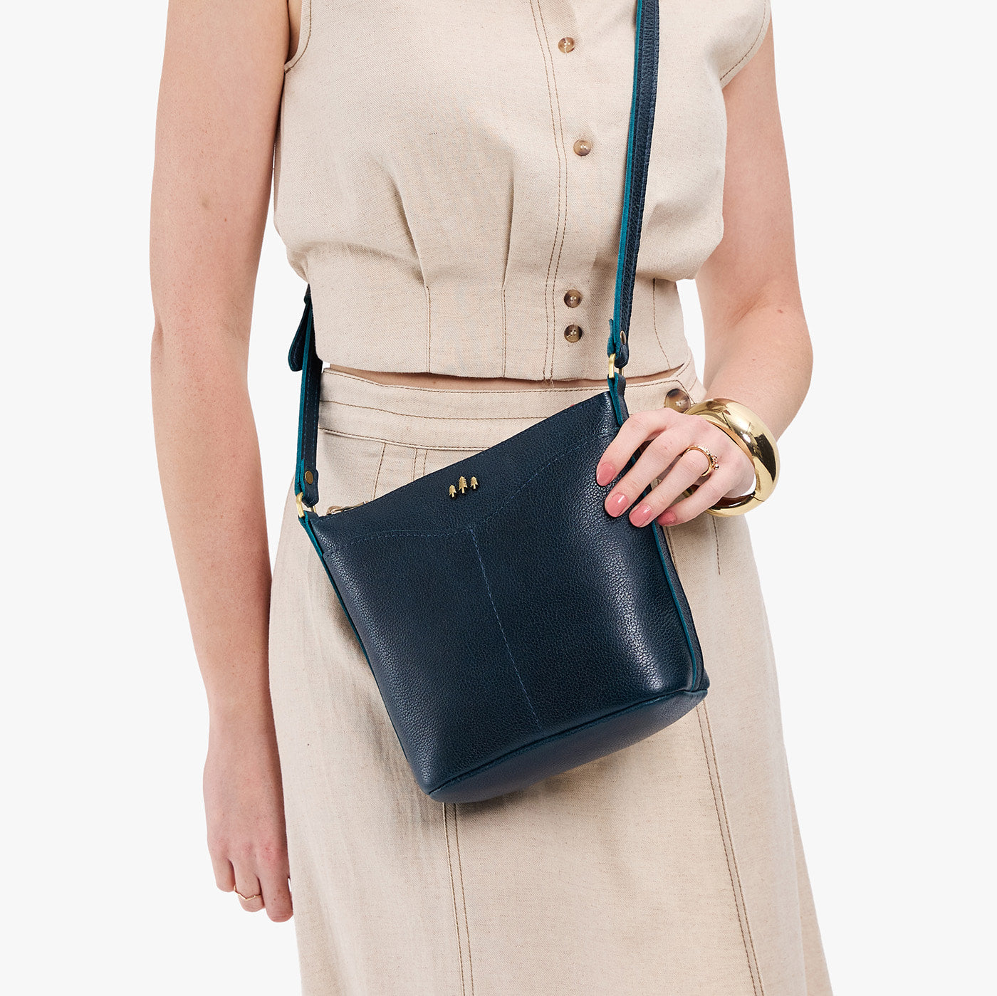 Boreal | Model wearing rectangular side bag with curved front pocket and metal tree shaped badge