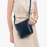 Boreal | Model wearing rectangular side bag with curved front pocket and metal tree shaped badge