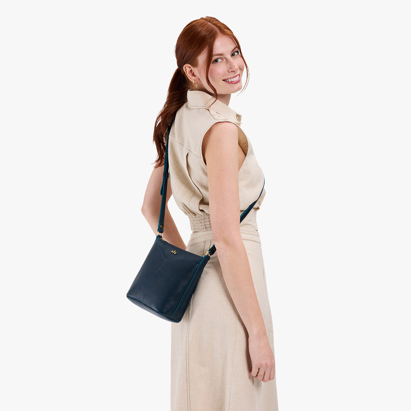 Boreal | Model wearing rectangular side bag with curved front pocket and metal tree shaped badge