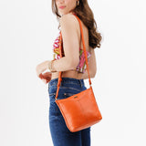 Cape Coral | Model wearing rectangular side bag with curved front pocket and metal tree shaped badge