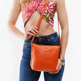 Cape Coral | Model wearing rectangular side bag with curved front pocket and metal tree shaped badge