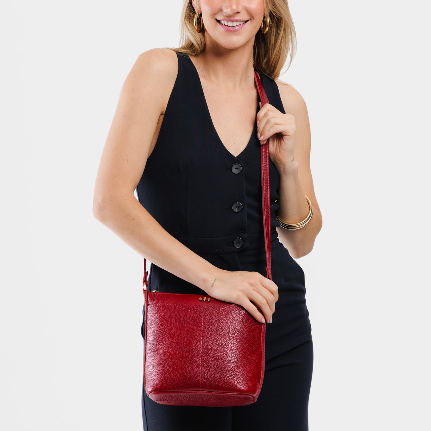 Chili Red | Model wearing rectangular side bag with curved front pocket and metal tree shaped badge