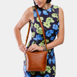 Sienna | Model wearing rectangular side bag with curved front pocket and metal tree shaped badge