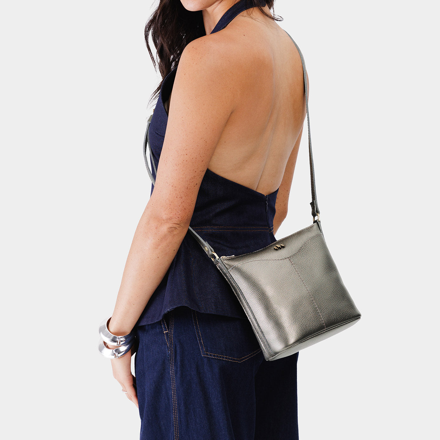 Stardust | Model wearing rectangular side bag with curved front pocket and metal tree shaped badge
