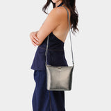 Stardust | Model wearing rectangular side bag with curved front pocket and metal tree shaped badge