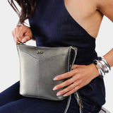 Stardust | Model wearing rectangular side bag with curved front pocket and metal tree shaped badge