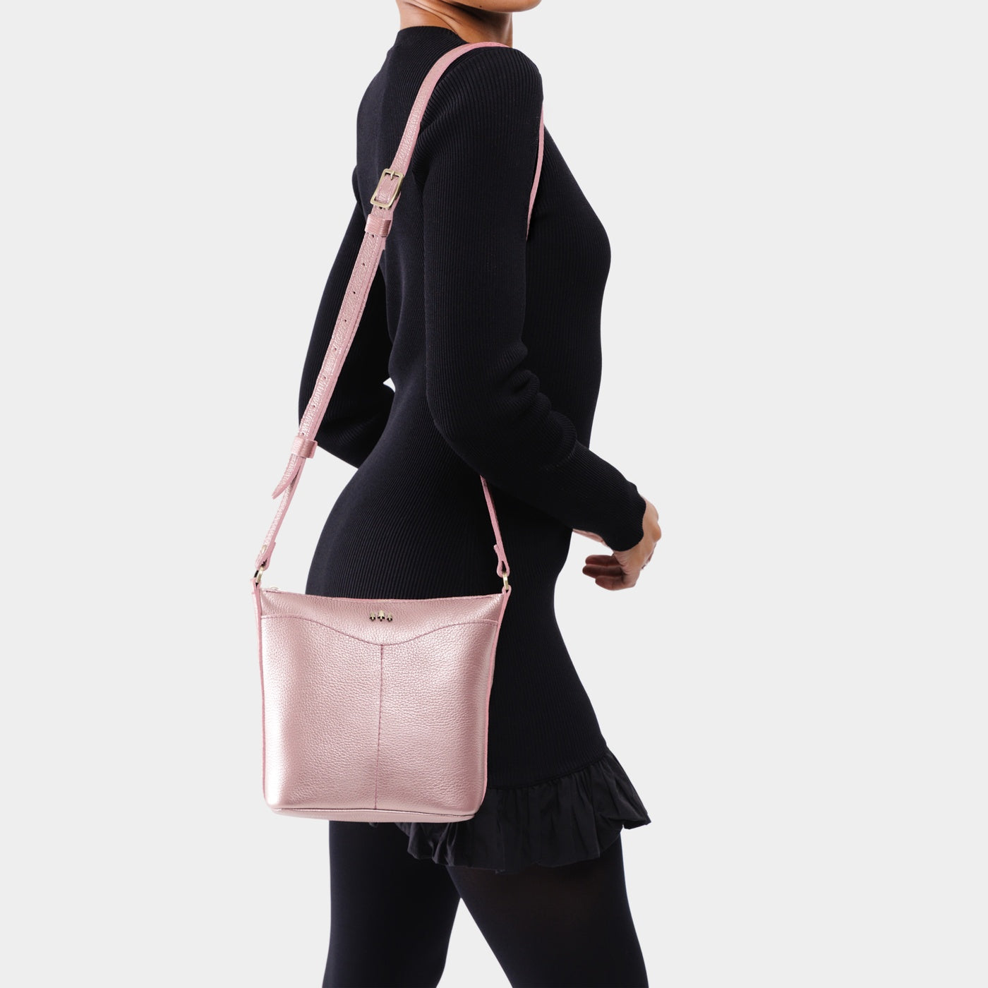 Supernova | Model wearing rectangular side bag with curved front pocket and metal tree shaped badge