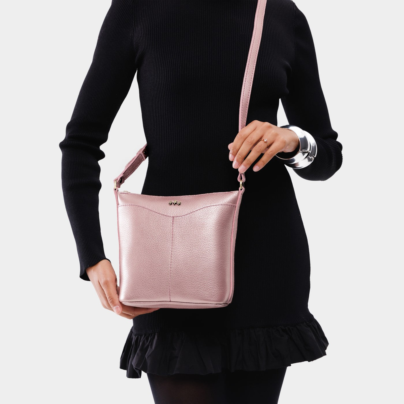 Supernova | Model wearing rectangular side bag with curved front pocket and metal tree shaped badge