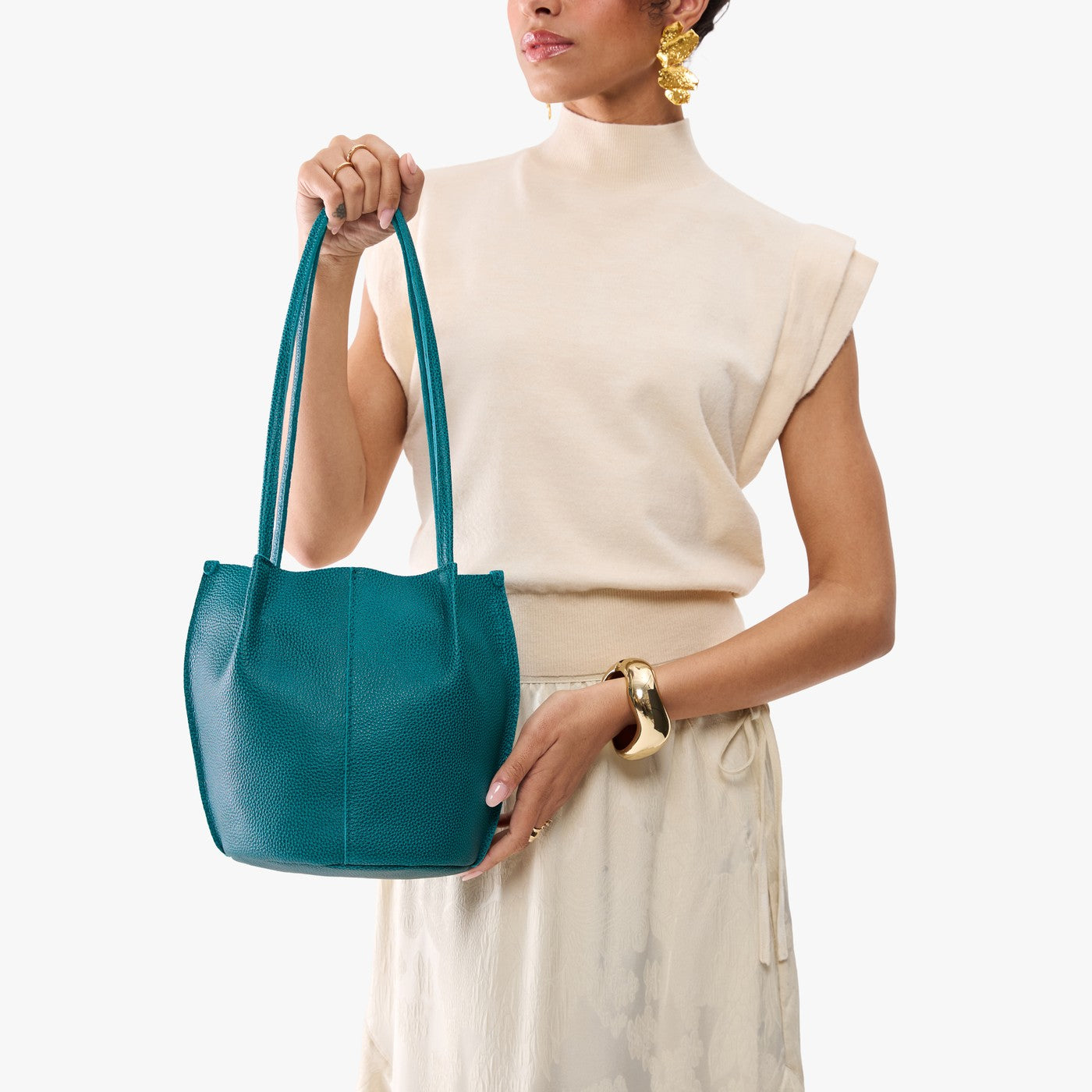 Aquarius*Classic | Model wearing matching white shirt and skirt carrying petite bucket shaped tote bag with matching leather handles