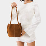 Jackson Classic | Model holding a brown leather tote bag 