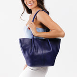 Cobalt Large | Model holding wide bucket shaped tote bag with matching leather handles