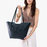 Boreal Oversized | Model holding extra wide bucket shaped tote bag with matching leather handles