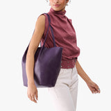 Empire Oversized | Model carrying extra wide bucket shaped tote bag with matching leather handles