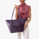 Empire Oversized | Model holding extra wide bucket shaped tote bag with matching leather handles