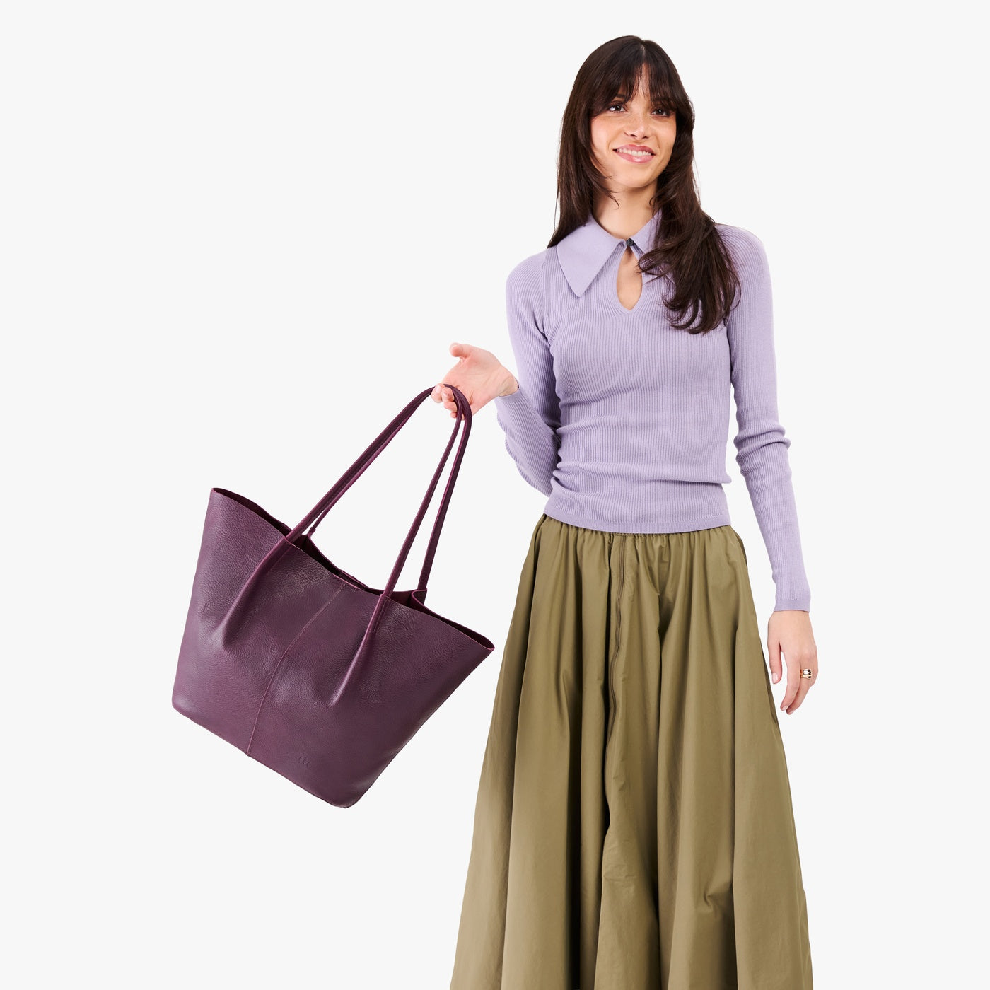 Plum*Oversized | Model holding extra wide bucket shaped tote bag with matching leather handles