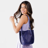 Cobalt Classic | Model holding a  leather tote bag 