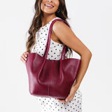 Orchid Large | Model holding wide bucket shaped tote bag with matching leather handles