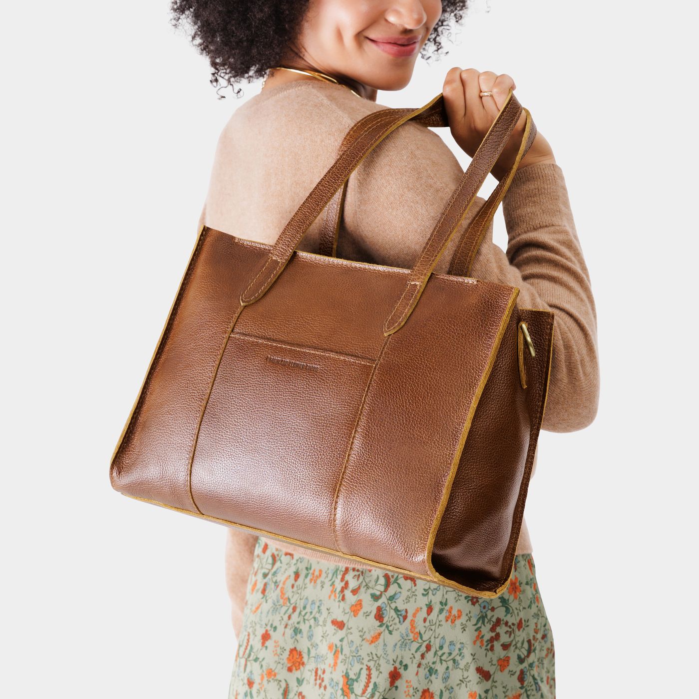 Asheville*East/West | Model wearing structured wide tote bag with overlapping panels and crossbody strap