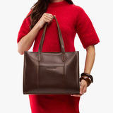 Chocolate Brown East/West | Model wearing structured wide tote bag with overlapping panels and crossbody strap